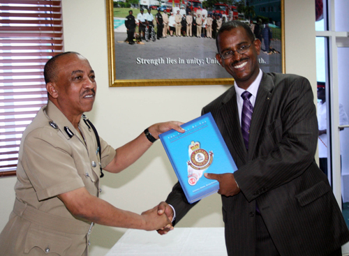 Tommy Turnquest shakes hands with Police Commissioner Paul Farquharson at the official launch of the Royal Bahamas Police Force's history book entitled “The